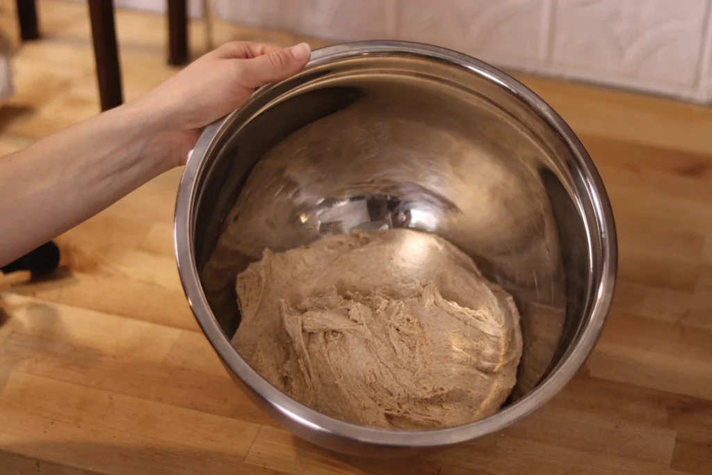 dough in a stainless steel mixing bowl