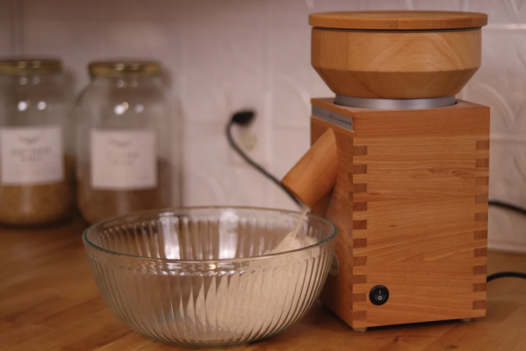 a komo grain mill with flour being milled